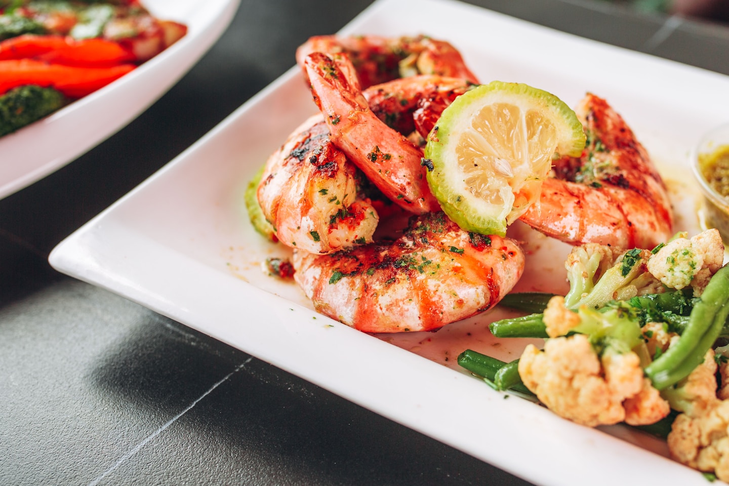 a white plate topped with shrimp and veggies